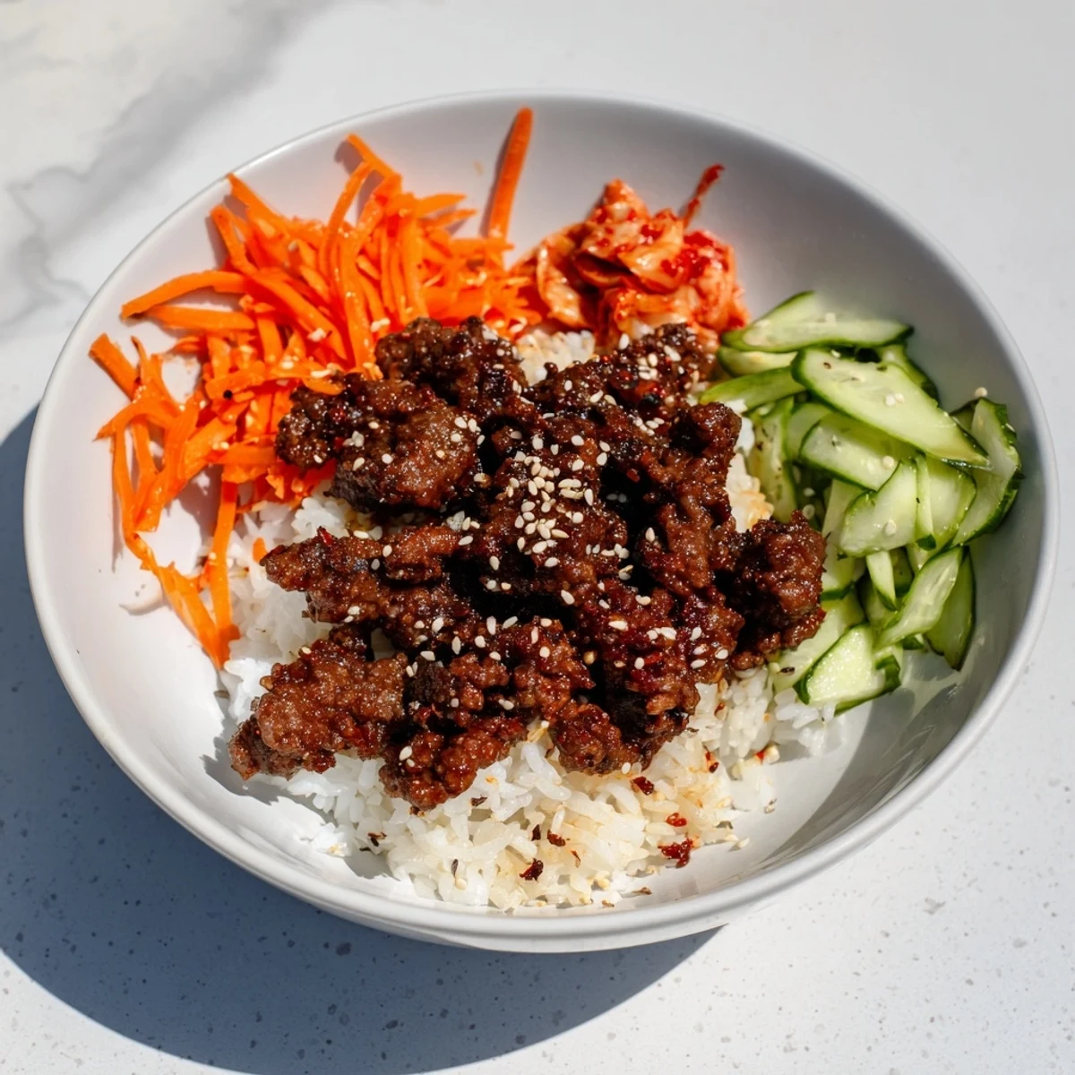 Steaming bowl filled with the savory Spicy Korean Beef Bowl, topped with fresh scallions and sesame seeds.
