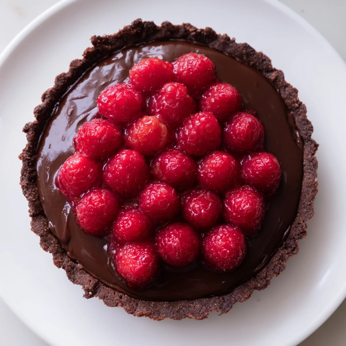 Imagine a slice of this chocolate raspberry tart; a heavenly dessert featuring fresh, plump berries.