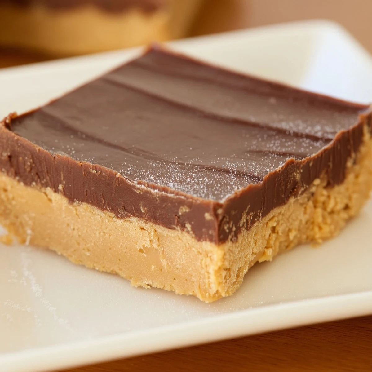 Smooth layers of chocolate and peanut butter fudge, a delicious classic dessert recipe.