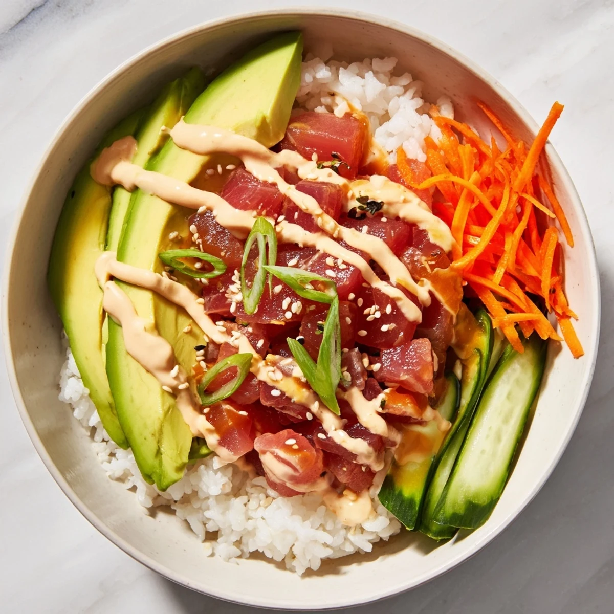 Deconstructed Spicy Tuna Roll Bowl, featuring glistening tuna and fresh, colorful vegetables.
