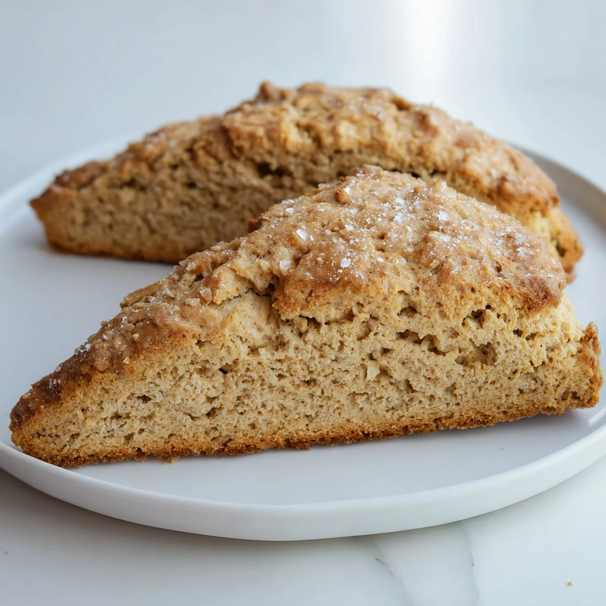 Golden-brown Spiced Chai Tea Scones, served warm with clotted cream, offering a comforting tea time treat.