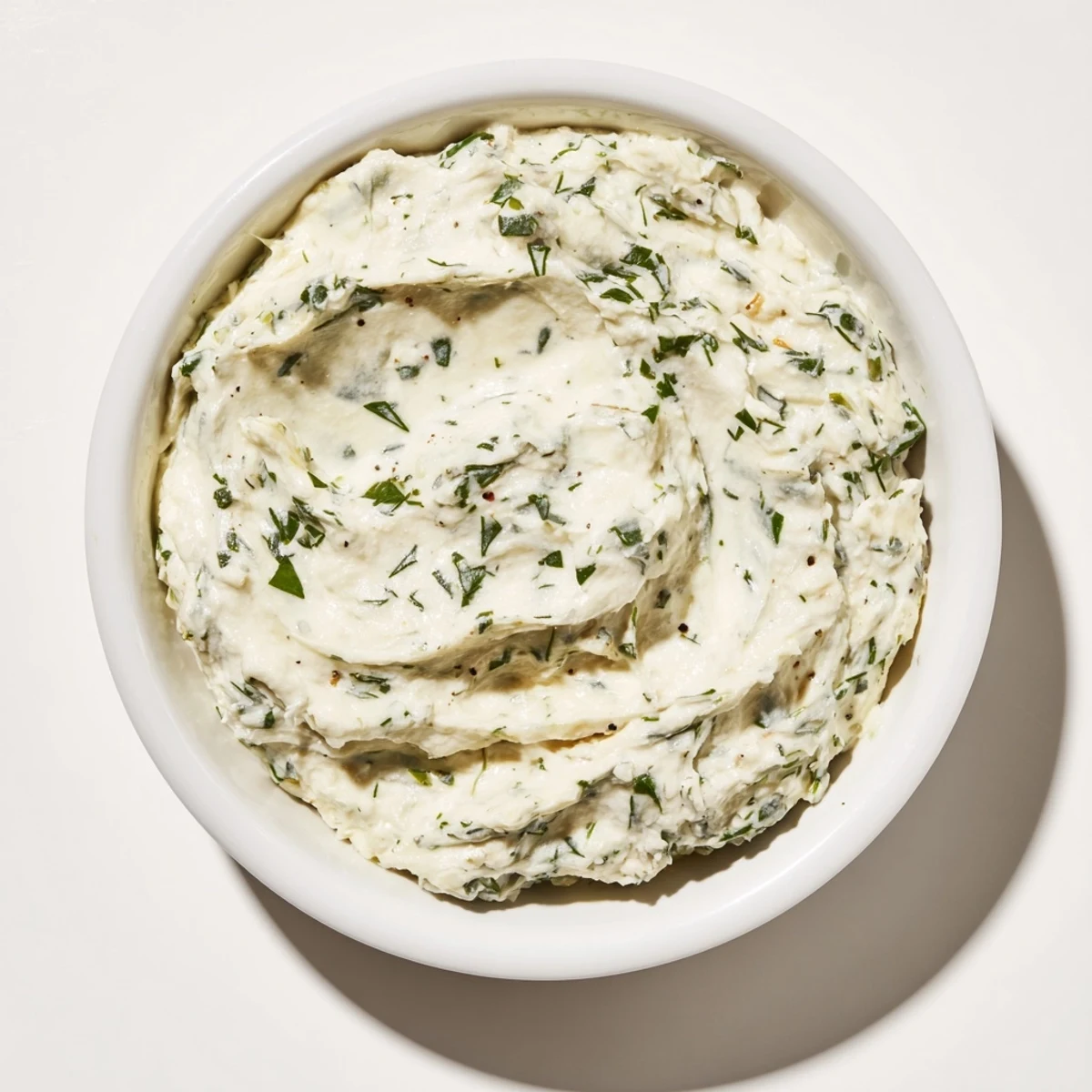 A vibrant photo of creamy herb dip, ready to be scooped up with crunchy vegetables and enjoyed.
