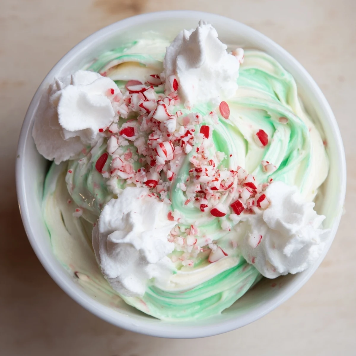 Vibrant green-swirled Twist Peppermint, ready to eat with crushed peppermint and whipped cream.