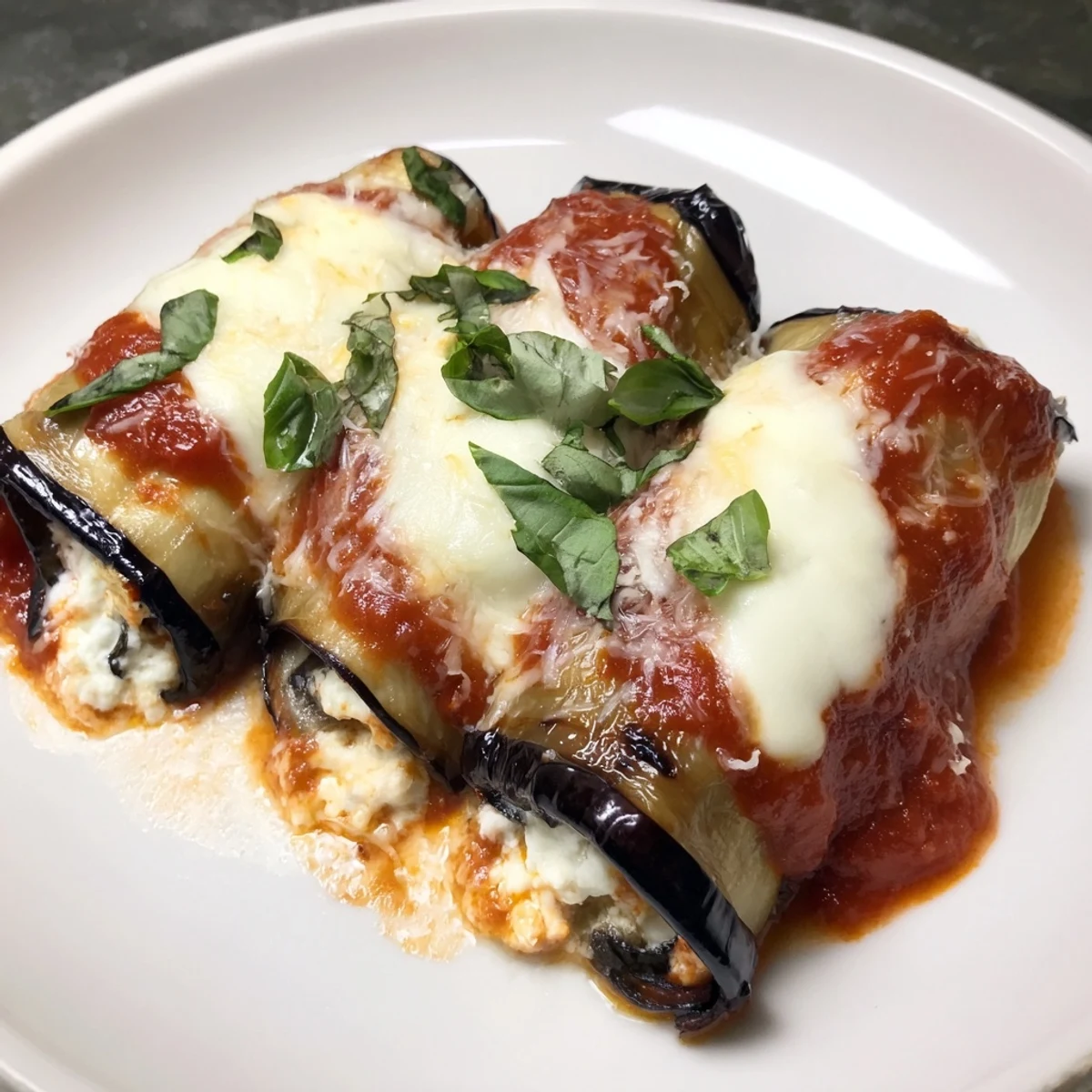 Enjoy the sight of flavorful Baked Eggplant Rollatini, rolled with creamy ricotta and bubbling marinara.