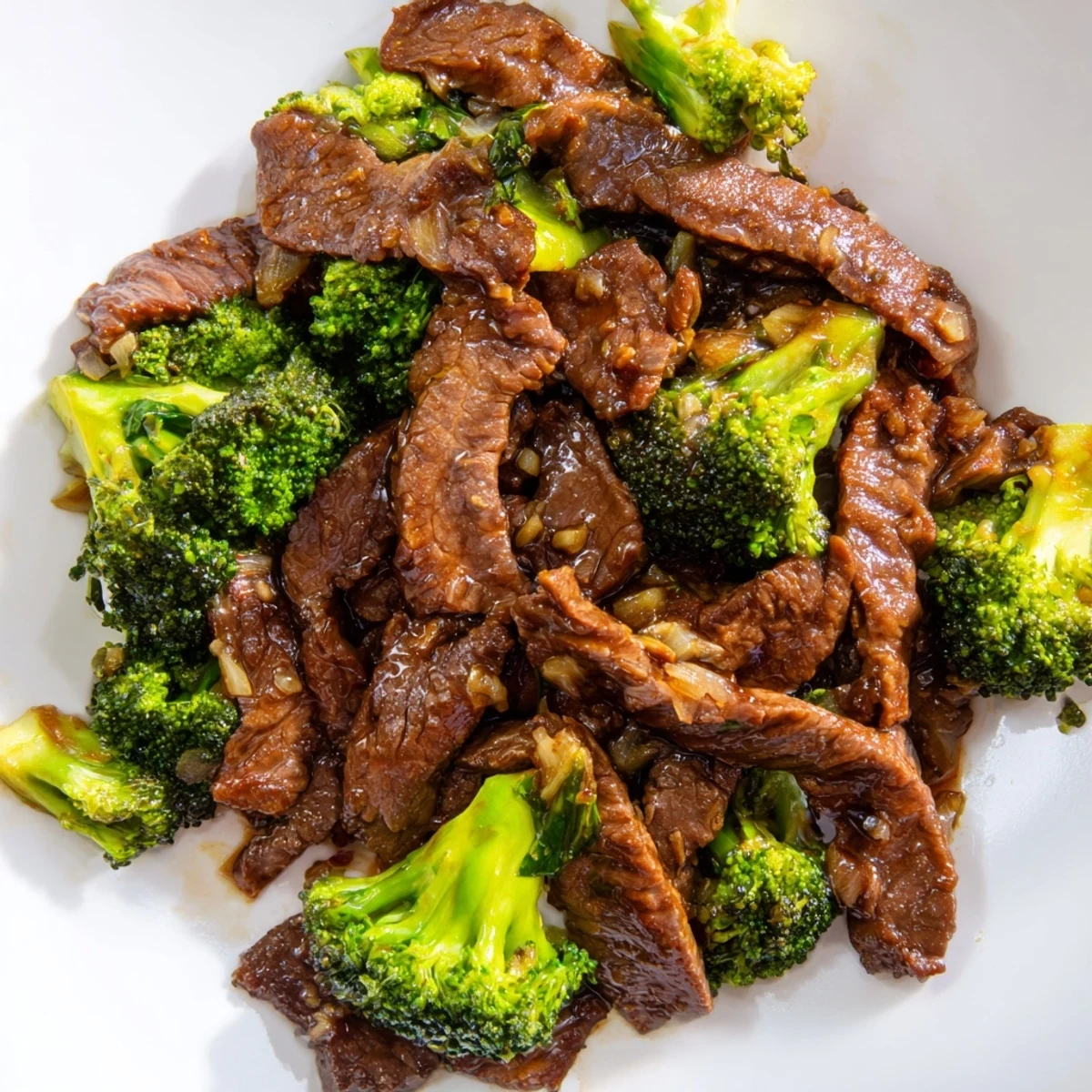 A close-up view of a hearty Beef and Broccoli Stir Fry with oyster sauce, garnished with sesame seeds and ready to eat.