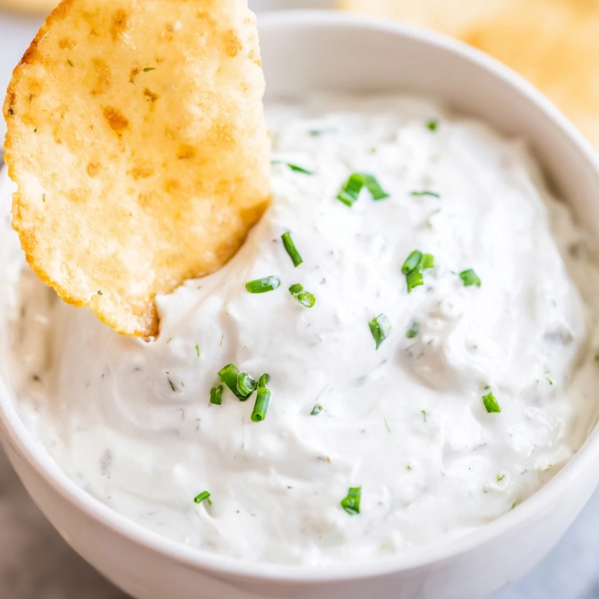 Golden crispy tortilla chips dip into a smooth, lightened-up version of the popular Creamy Dip with Chips snack.