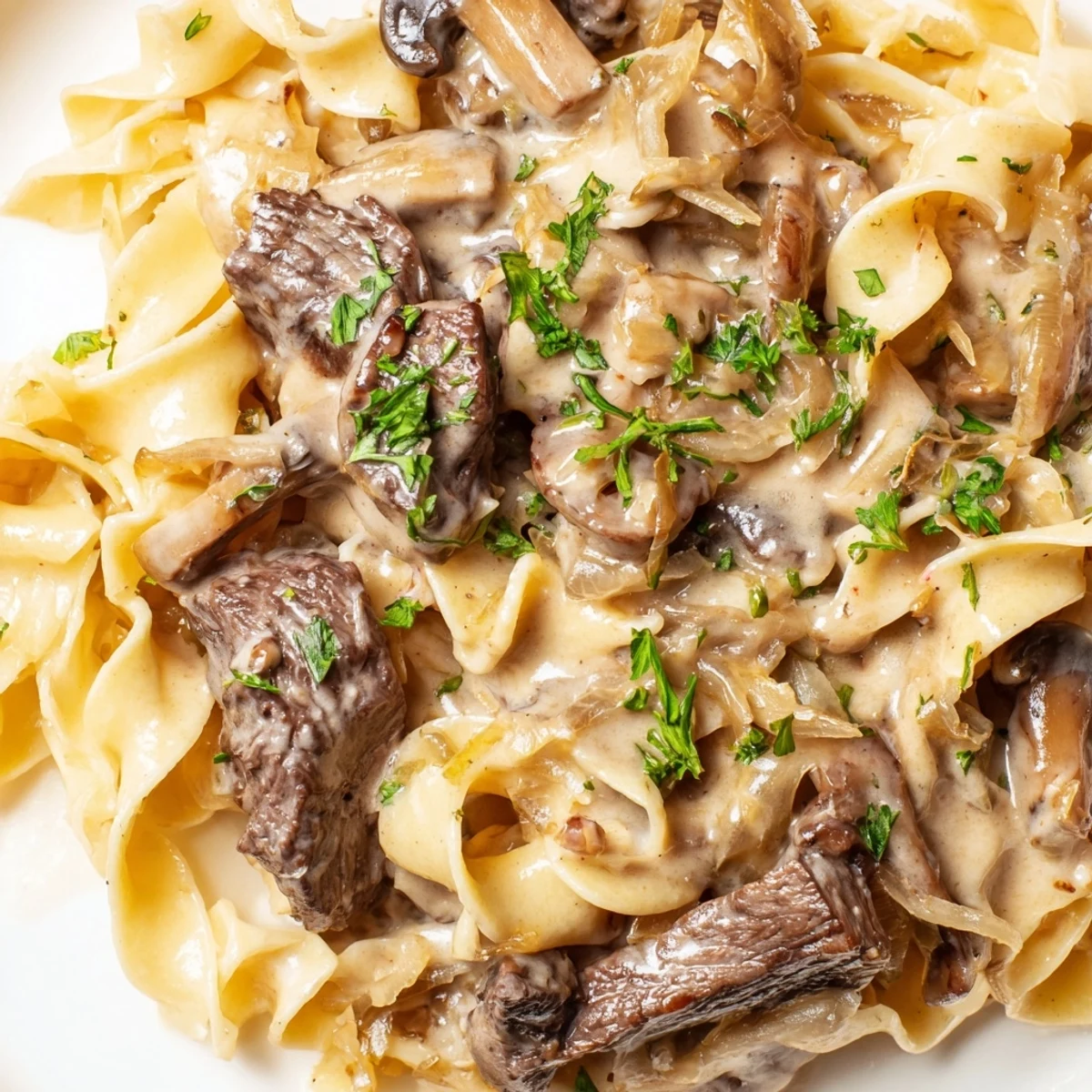 Tender beef strips and sautéed mushrooms in creamy gravy over wide egg noodles, a classic Beef Stroganoff.