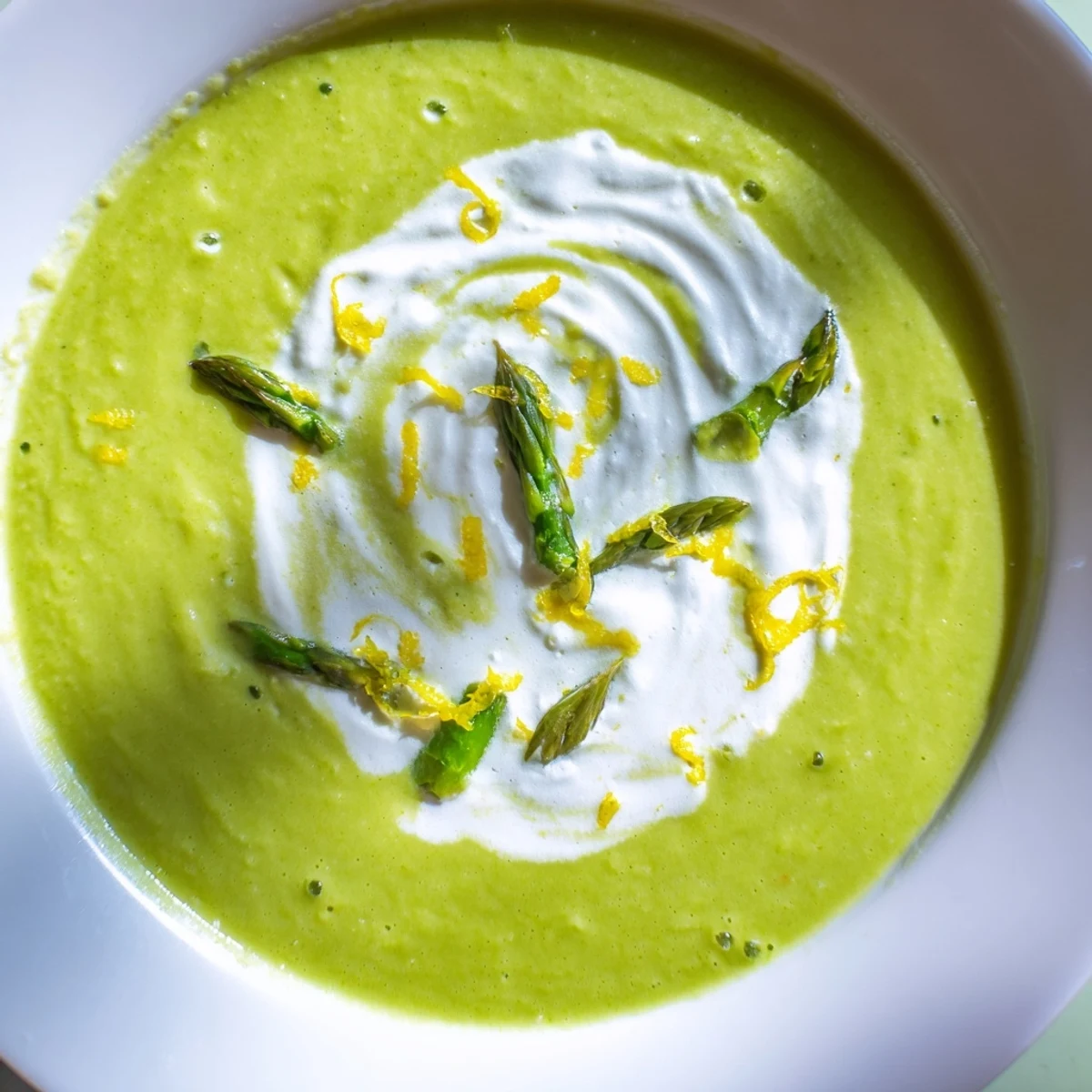 This velvety green soup features a swirl of crème fraîche and bright lemon, perfect for spring.