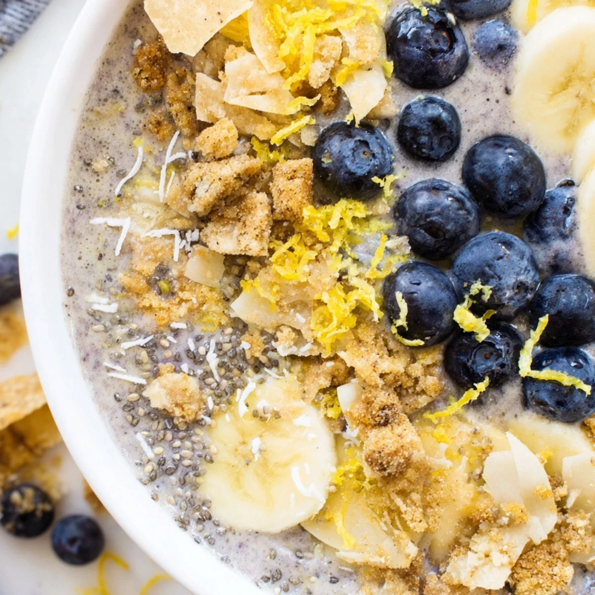 Vibrant Lemon Blueberry Smoothie Bowl with textured toppings, ready to eat for a healthy breakfast.