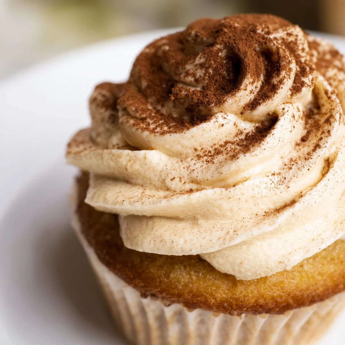 Close-up of frosted Irish Cream Cupcakes with a chocolate garnish, ideal for any dessert table or afternoon coffee treat.