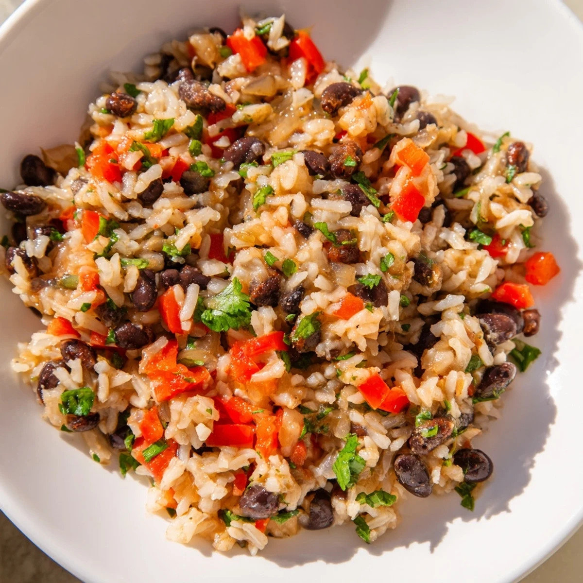 Fluffy white rice and creamy black beans simmered with smoked paprika and cumin for a savory vegan dinner.  