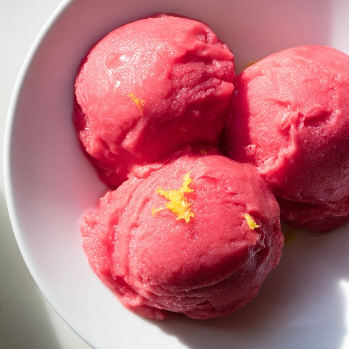 This easy homemade Strawberry Lemonade Sorbet freezes into vibrant pink scoops bursting with fresh berry tang and bright citrus notes.
