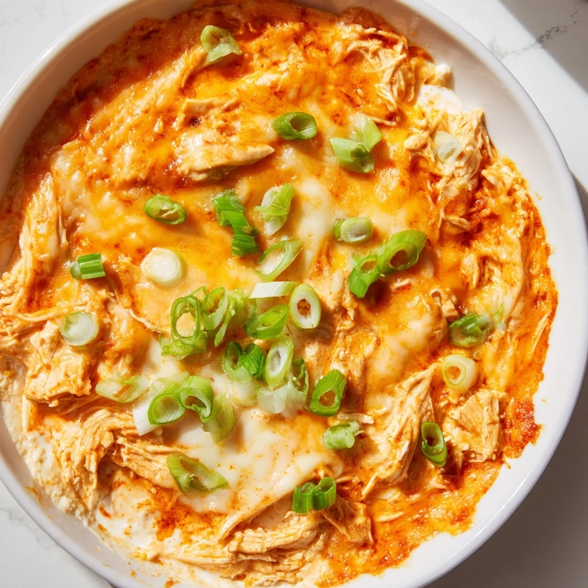 Golden baked Spicy Buffalo Chicken Dip with Tortilla Chips served warm for game day gatherings.