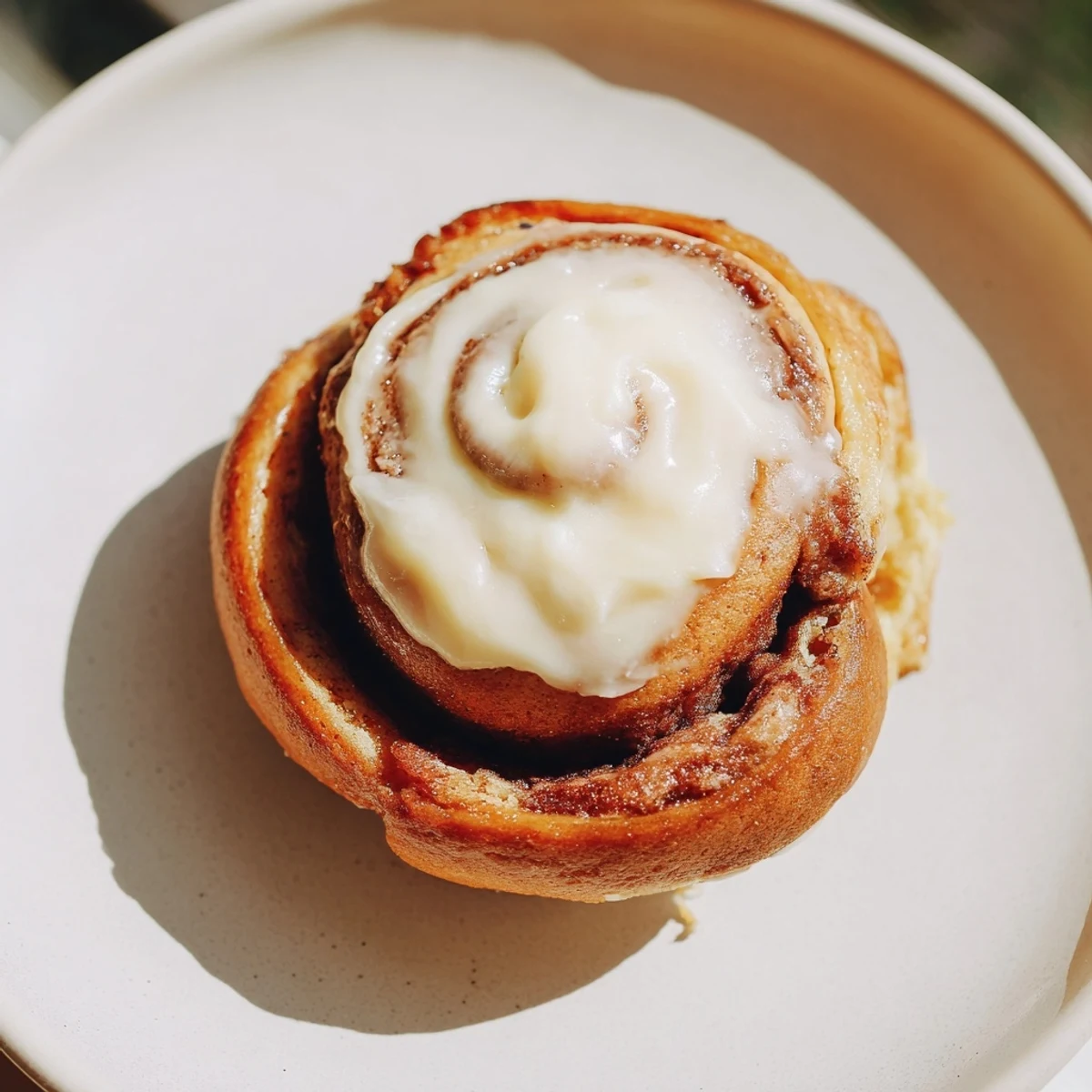 Freshly baked Keto Cinnamon Buns arranged in a round pan, golden-brown with a soft fluffy texture and a sweet aromatic cinnamon aroma.