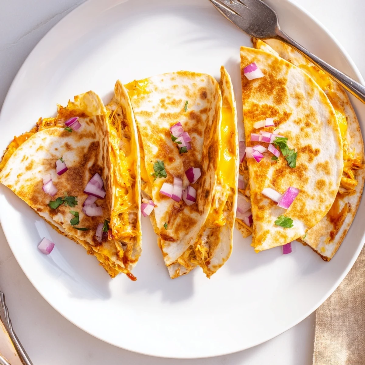 Golden-brown Hot Honey BBQ Chicken Quesadillas sizzling in a skillet, filled with melted cheese and tangy sauce. 