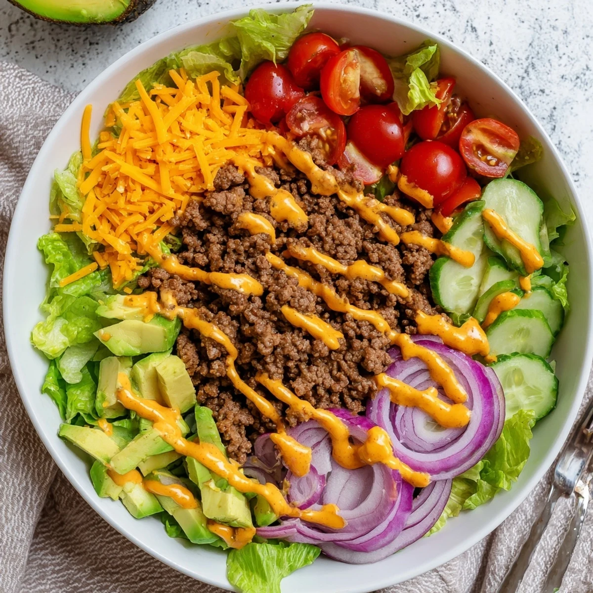 A close-up of deconstructed Burger Bowls with beef, pickles, tomatoes, and onions, ready to serve.
