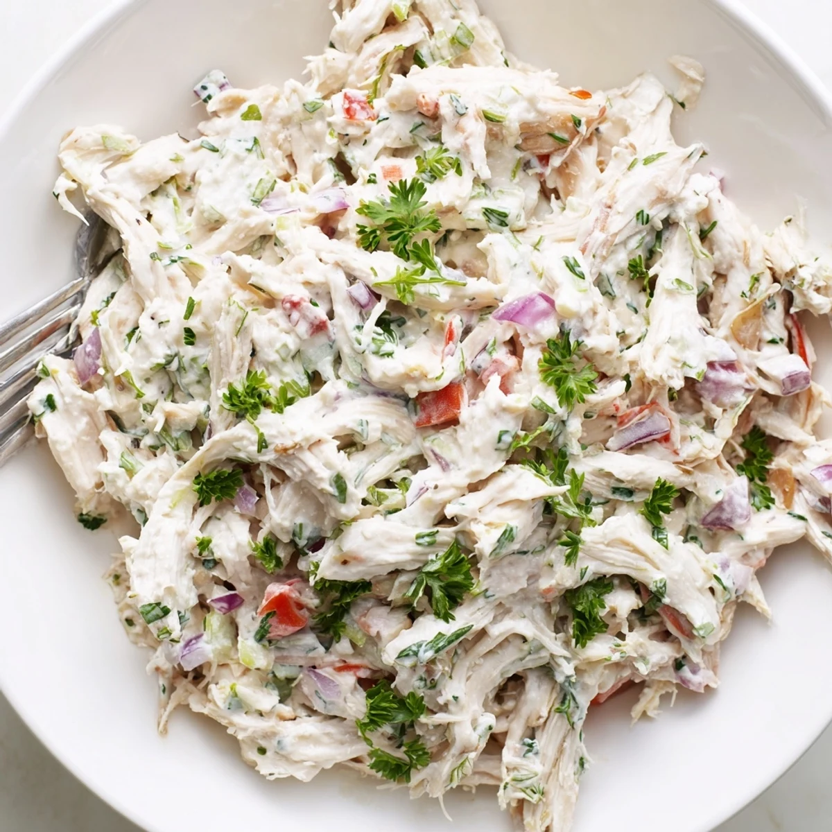 Light and healthy Greek yogurt rotisserie chicken salad served on a bed of crisp greens