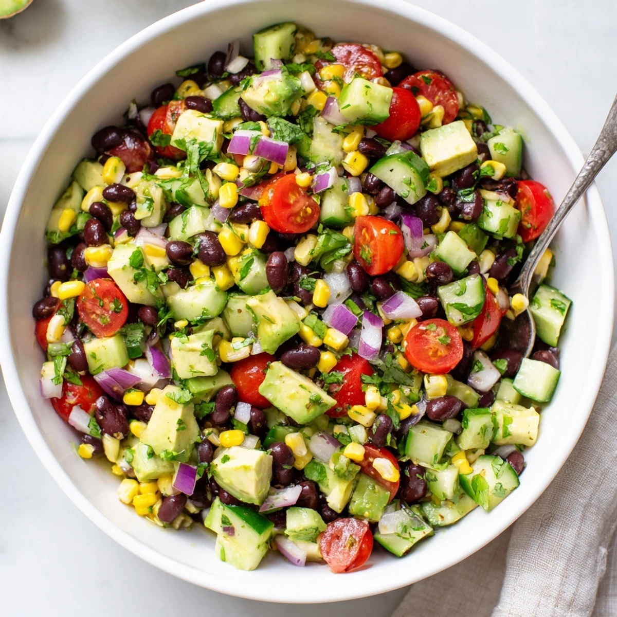 Vibrant Mexican-inspired chopped black bean salad featuring crisp corn peppers tomatoes and tangy lime dressing