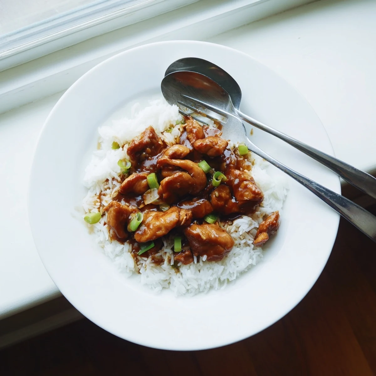 Tender stir-fried Mongolian chicken drizzled with savory brown sugar garlic glaze and fresh scallions