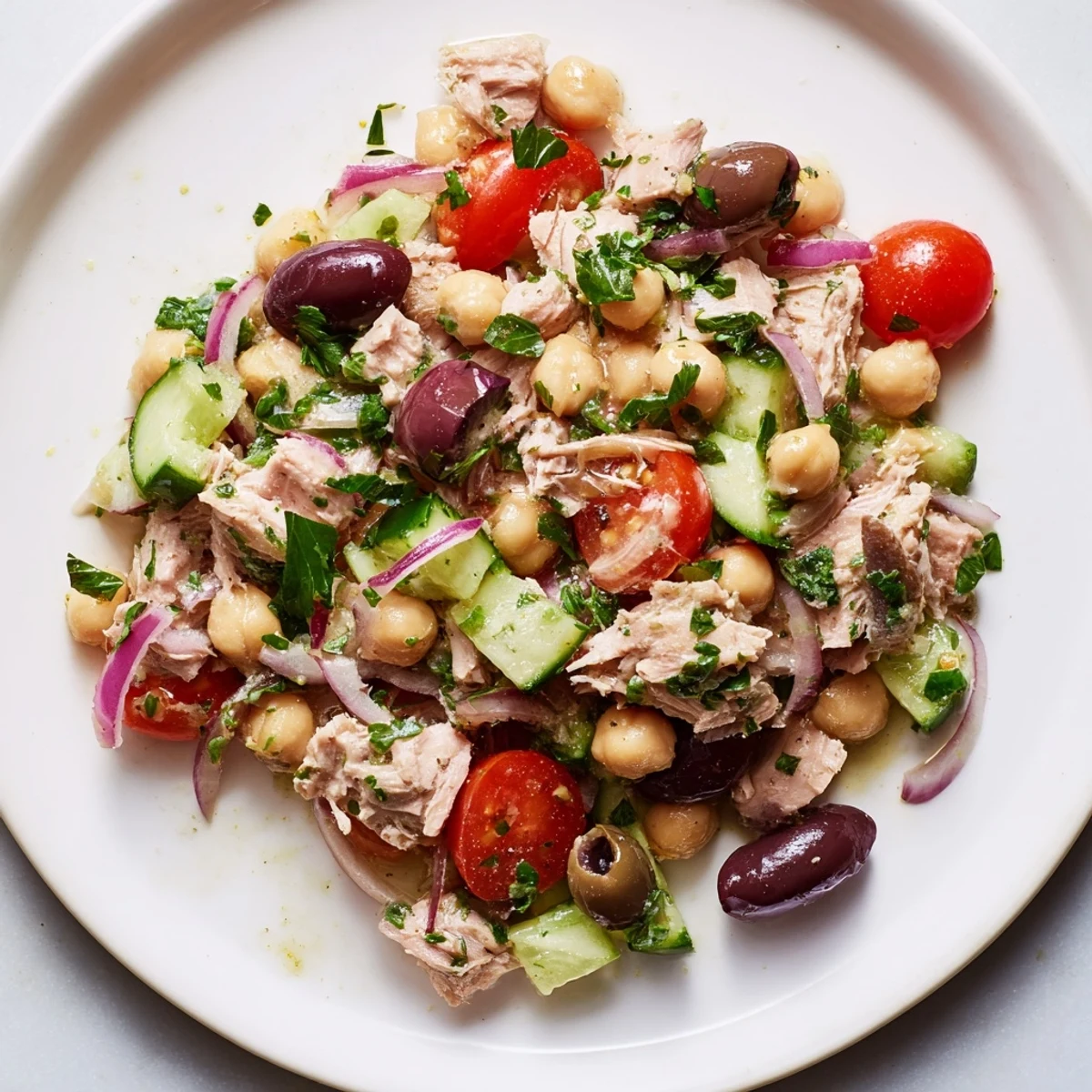 Protein-packed hearty tuna and garbanzo bean salad tossed with zesty dressing and colorful vegetables for a satisfying meal