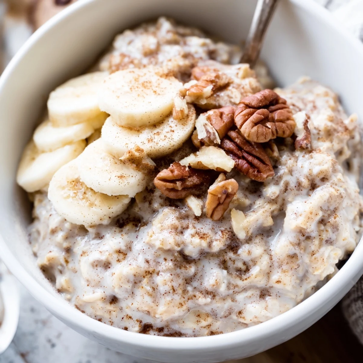 Creamy brown sugar overnight oats topped with fresh banana slices and crunchy walnuts in a glass jar
