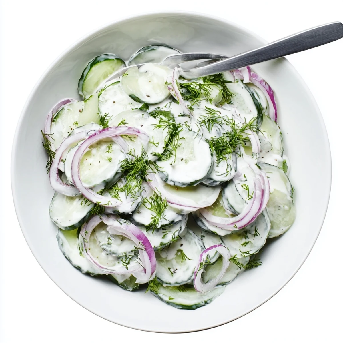 Garden fresh cucumber salad coated in a thick creamy dill dressing served in a white bowl