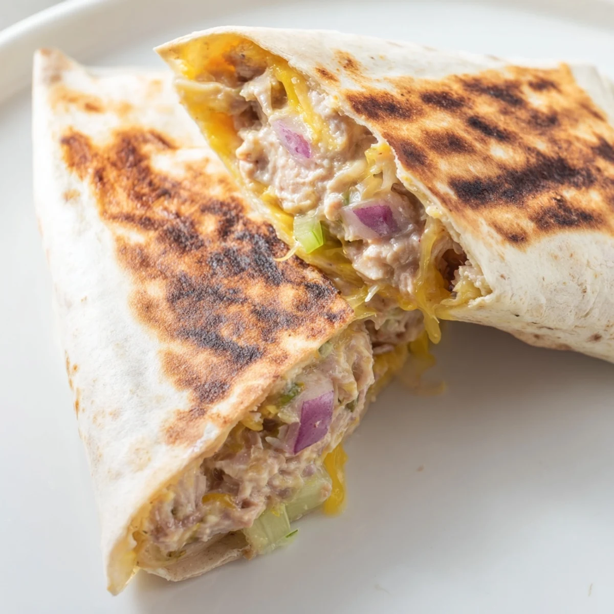 Flour tortilla packed with creamy tuna salad and shredded cheese, pan-fried until crispy