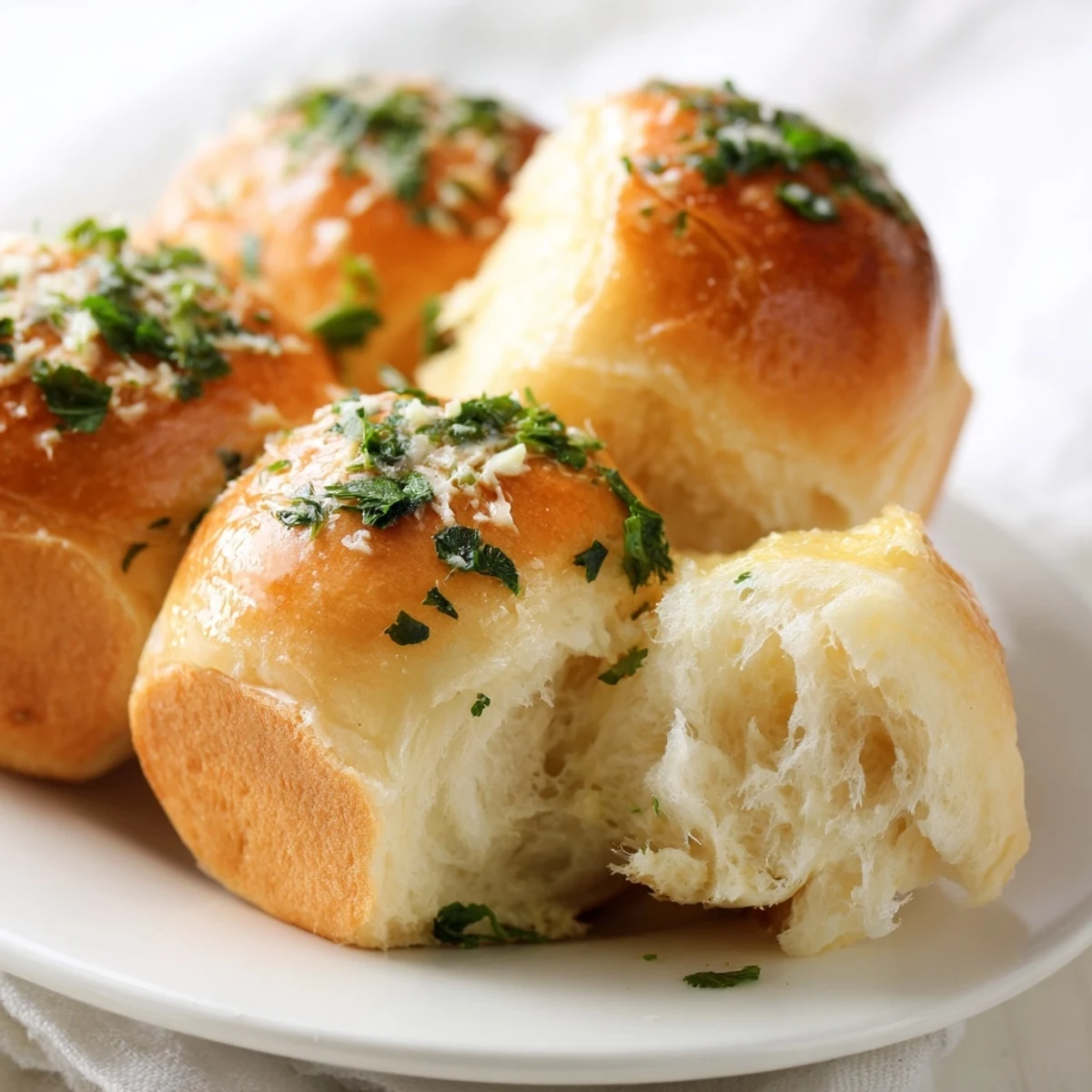 Soft fluffy garlic bread rolls brushed with melted butter and aromatic garlic herb filling