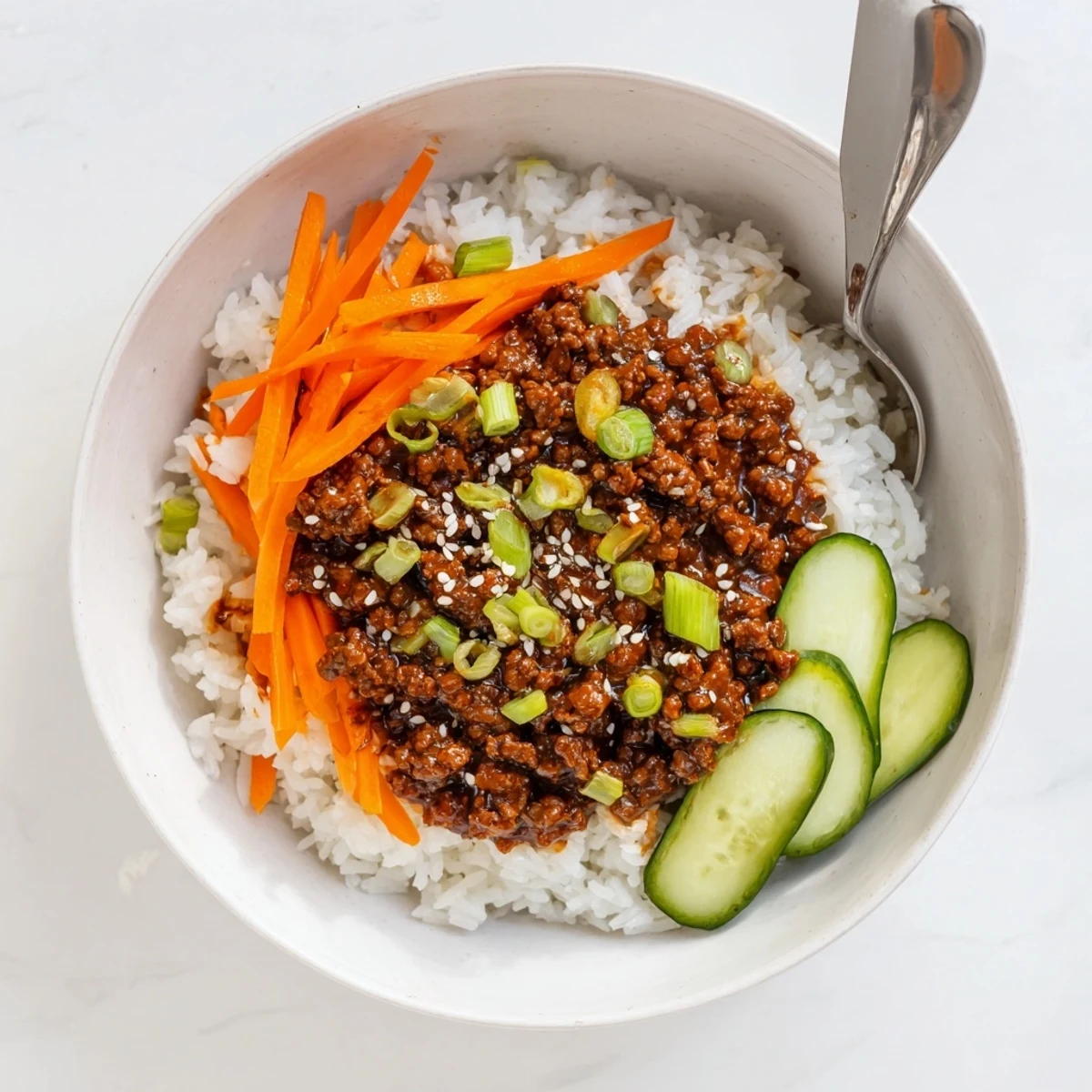 Korean beef bowls featuring caramelized ground beef, crisp vegetables, and glossy sauce on fluffy jasmine rice