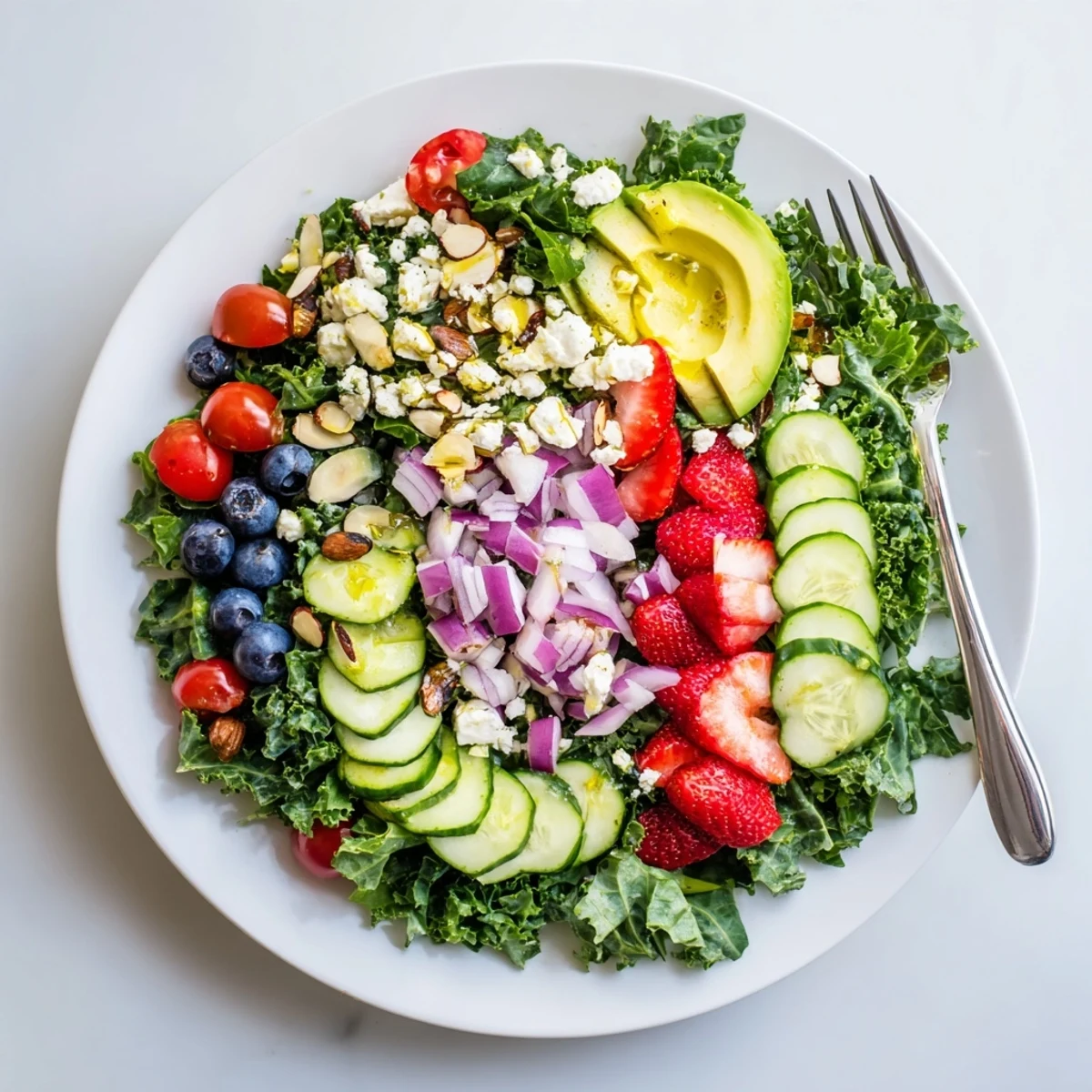 Hearty chopped kale tossed with juicy strawberries, feta crumbles, and crisp vegetables in a zesty vinaigrette.