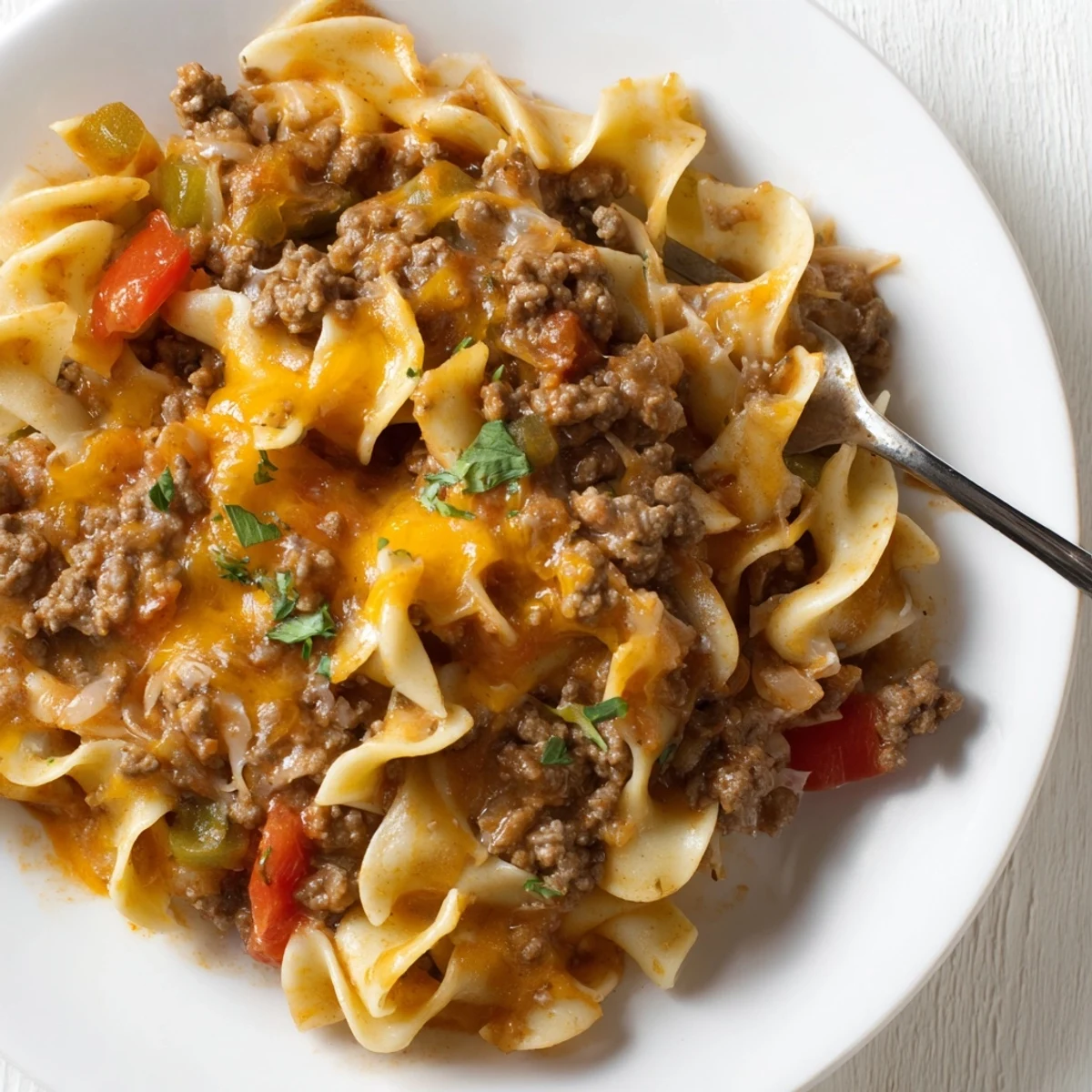 Hearty Beef Noodle Casserole bubbling with melted cheddar, ready for family dinner.