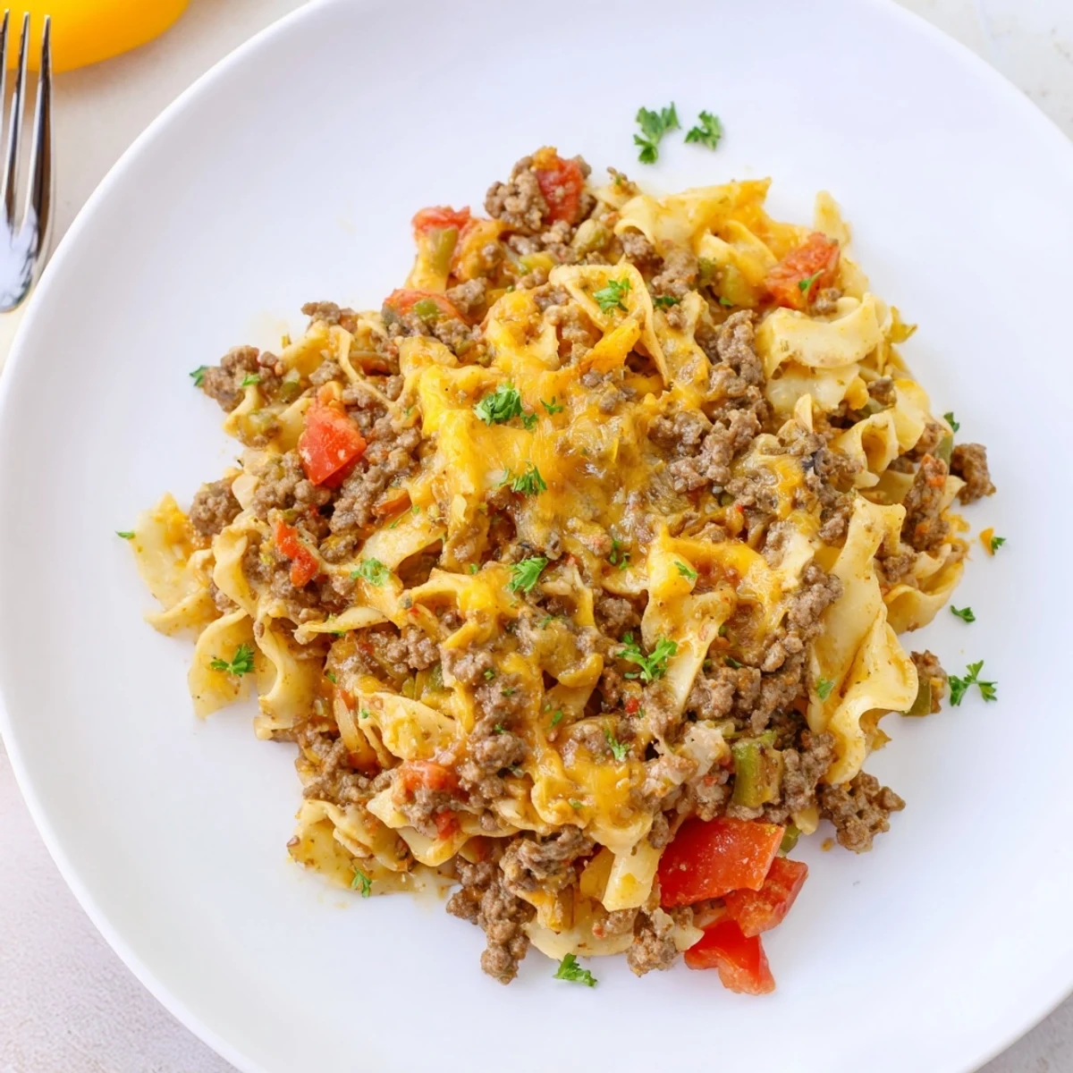 Comforting Beef Noodle Casserole showcasing saucy beef, tender noodles, and parsley garnish.