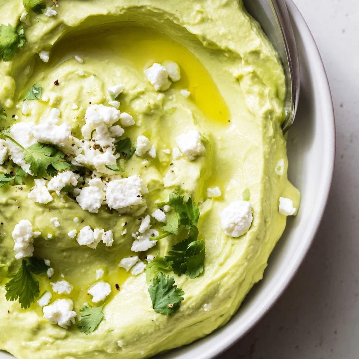 Thick, tangy Creamy Avocado Feta Dip served with warm pita chips