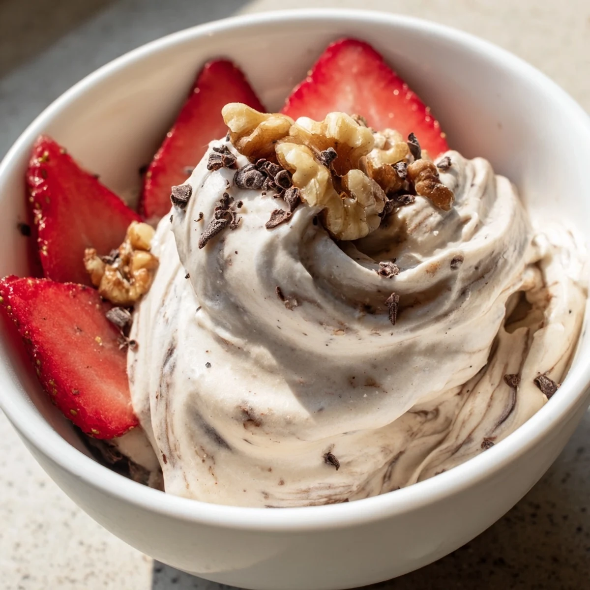 Vegan banana-based healthy nice cream recipe swirled with berries and garnished with colorful toppings