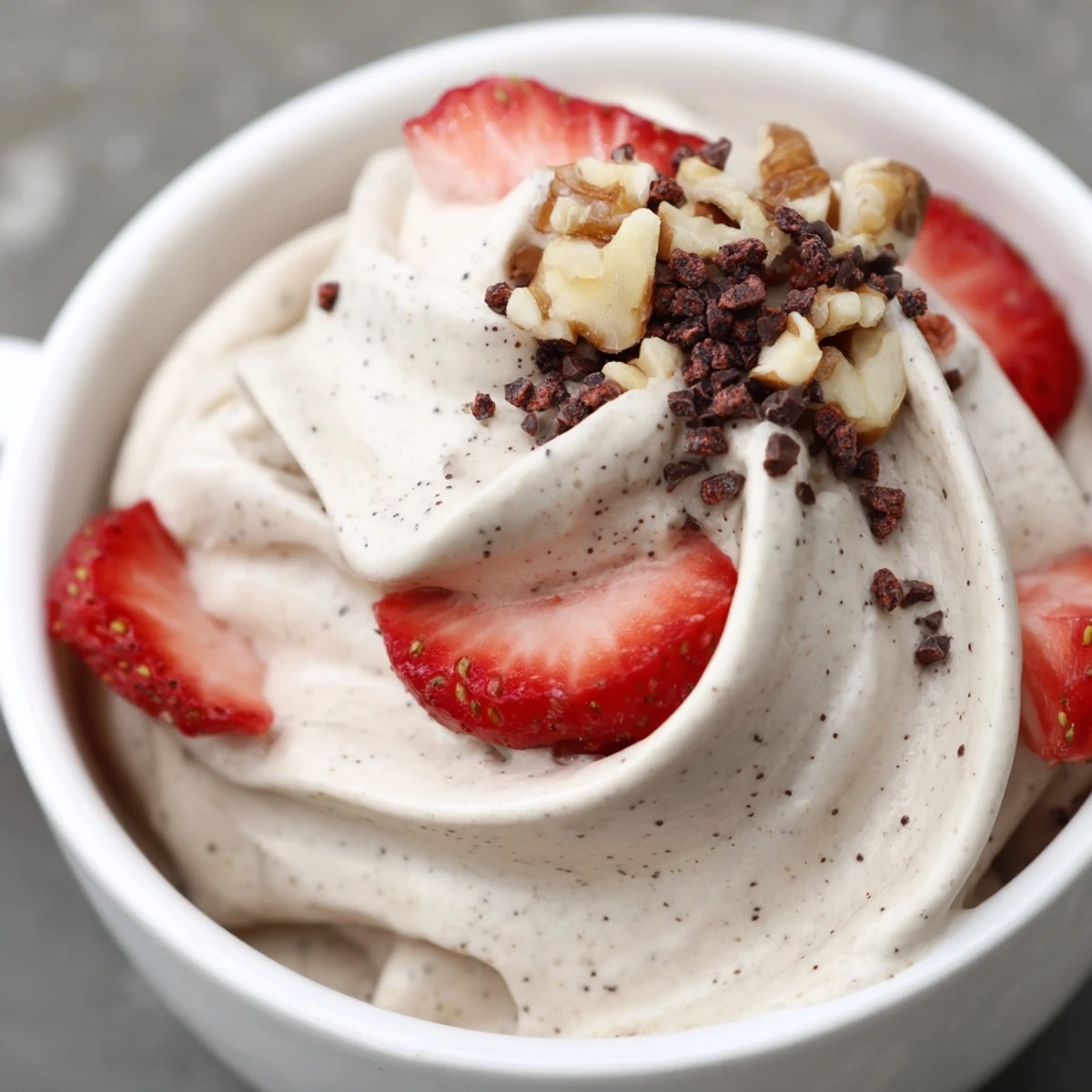 Dairy-free healthy nice cream recipe in rustic bowl featuring smooth texture and cacao nib sprinkles