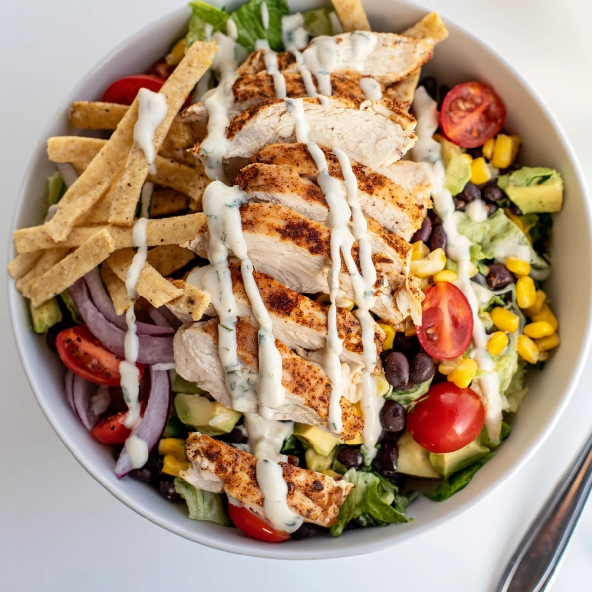 Bright Spicy Southwest Salad With Spicy Ranch Dressing topped with creamy avocado.