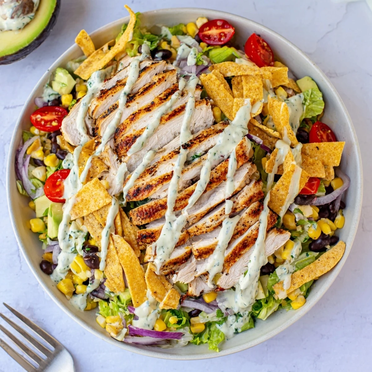 Spicy Southwest Salad With Spicy Ranch Dressing piled with grilled chicken, crisp tortilla strips.