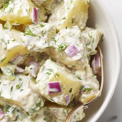 Creamy Potato Salad with Fresh Dill served chilled at a backyard barbecue.
