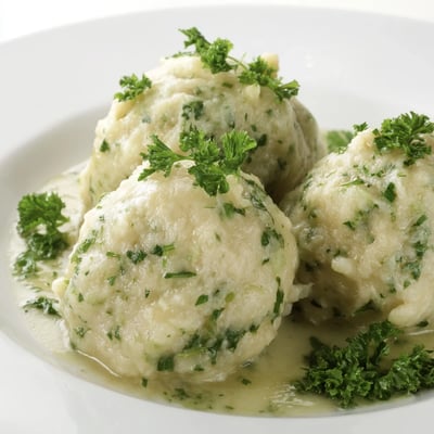 German Cabbage Dumplings served warm with melted butter, showcasing their fluffy texture and aromatic nutmeg seasoning.