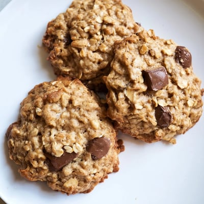 Chewy banana oatmeal cookies with visible oats and golden brown edges stacked together