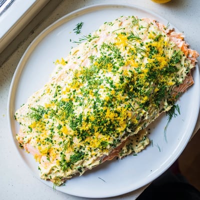 Tender baked salmon topped with melted garlic herb Boursin cheese, garnished with chives and dill.
